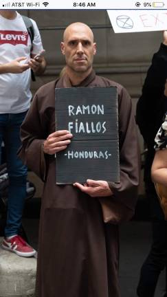 Buddhist monk joins Extinction Rebellion Protesters carry gravestones of climate activists killed around the world.