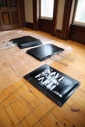 At a sign painting party in Milford, volunteers paint over old, donated political yard signs and then stencil them when dry.