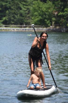 Kate Assaraf with her younger son, Des, on the lake where they live in Sparta, NJ