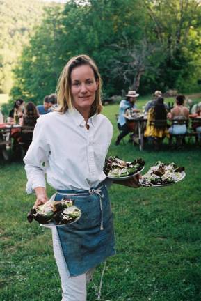 Rebecca serving up a family dinner. People came most weekends over this past summer to be fed.