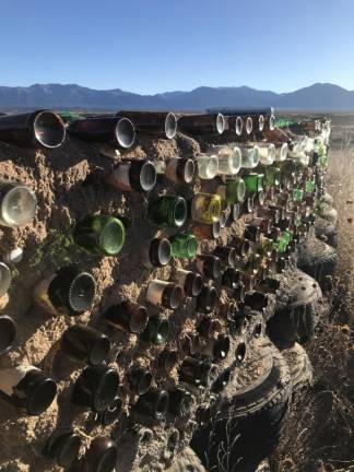 A bottle adobe wall and a foundation in the works.