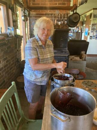 Julie Rawson in her farm kitchen. September finds Rawson preserving tulsi, husk cherries, chard, soybeans, broccoli, kale, cucumber pickles, grape juice, applesauce, canned tomatoes and cabbage. October? Garlic for garlic powder, cauliflower, collards, celery, parsley, hemp, winter squash, apple cider and pears.