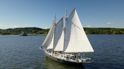 The Apollonia sailing down the Hudson toward Rondout Lighthouse in Kingston. Undeterred by the prospect of towing a 64-foot schooner over 70 miles of road festooned with power lines, Merrett bought the ship for one-thirteenth the asking price.