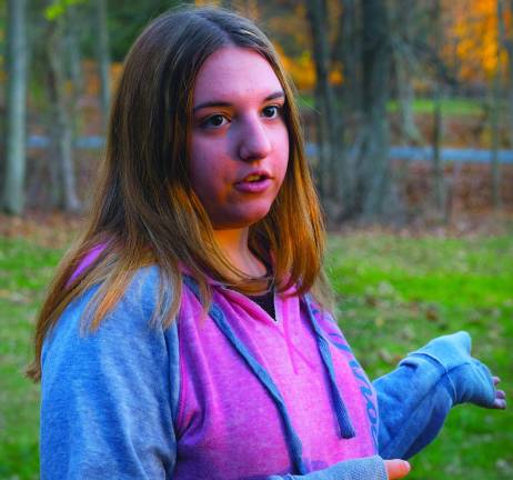 Rachel Beck, 15, is working with two friends to collect and redeem trashed bottles and cans, and donate the proceeds to a cat shelter. The three girls stayed after the homecoming football game to collect the bottles lying around.