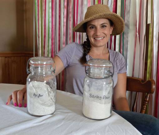 Showing off Rye &amp; Barley flour ground from her small grains business