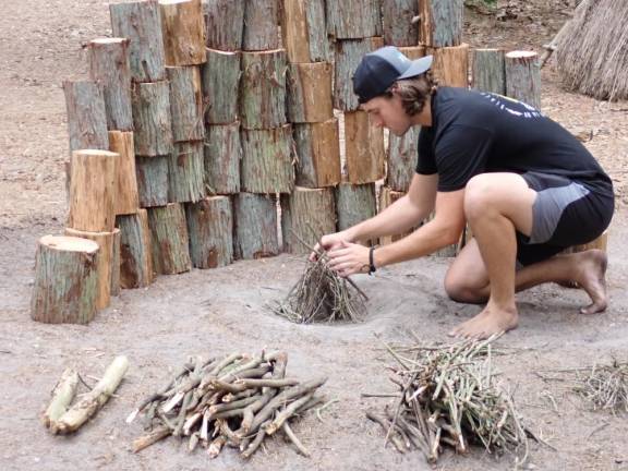 River Brown, Tom’s youngest son, demonstrating how to make a tipi fire. When it’s really cold, a heat shield (made out of logs here) reflects the fire’s warmth back toward you.