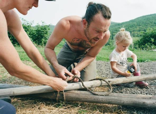 Raising a tipi with a friend.