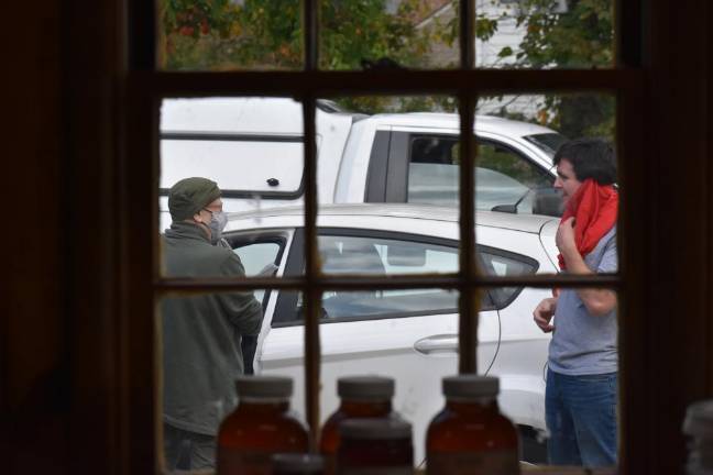 The EpiPen kid Harrison walks one of his first custoemrs to her car on his second Friday in business.