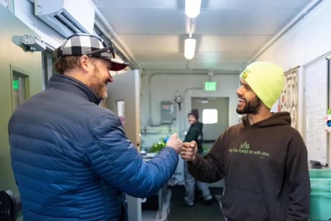 Danny Amend greets Sherwood Ludwig, operations manager at Wally Farms, the umbrella organization incubating Far Out Continainer Farm.