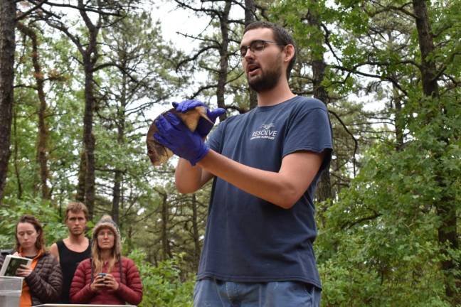 Coty Brown demonstrates how to gut and prepare a fish, before cooking it over campfire coals.