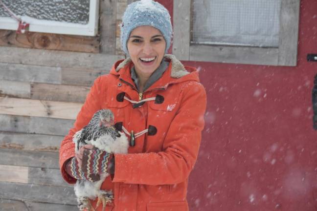 Venjara with Mouse, one of her eight chickens.