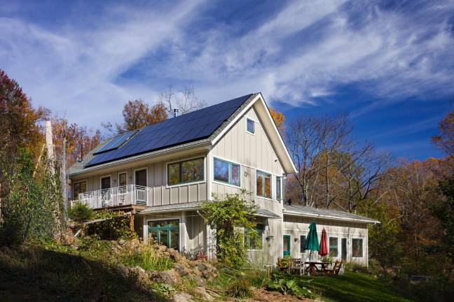 Rooftop solar generates the house's electricity and hot water.