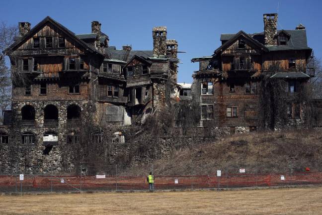 A worker watches the demolition of Bennett School.