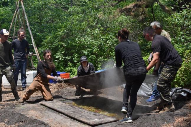 Volunteers open a hidden steam pit during the cooking lecture, revealing leaf-wrapped vegetables and chickens that had been cooking right under our noses. We had been looking right at it but had no idea it was there.