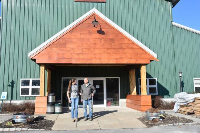 Lauren and Dale Van Pamelen in front of the portico they spent three grueling days refinishing.