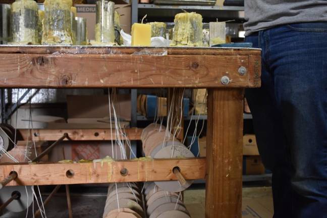 The EpiPen kid Making candles. Harrison bought his candlemaking equipment used from another candlemaker who was hanging it up.