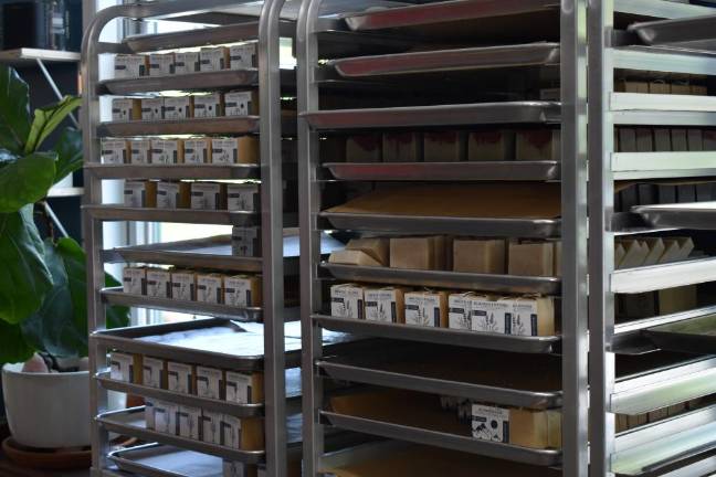 Trays of soap individually packaged for sale in recycled butcher paper and string.