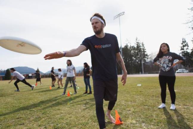 Mike Grant coaching indigenous youth as part of a reconciliation project.
