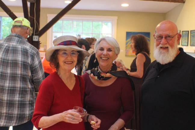 Stay tuned: the little gallery abides L to R: Poet Donna Spector, artists Pat Foxx and David Horton at a 2019 opening at the Amity Gallery. In past incarnations, the gallery space has been a carriage house, mechanic’s shop and nursery.