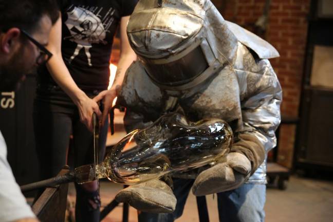 McKinley’s gaffer’s assistant wears a Kevlar suit to handle molten glass.