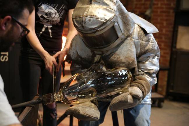 Sidestepping angst McKinley’s gaffer’s assistant wears a Kevlar suit to handle molten glass.