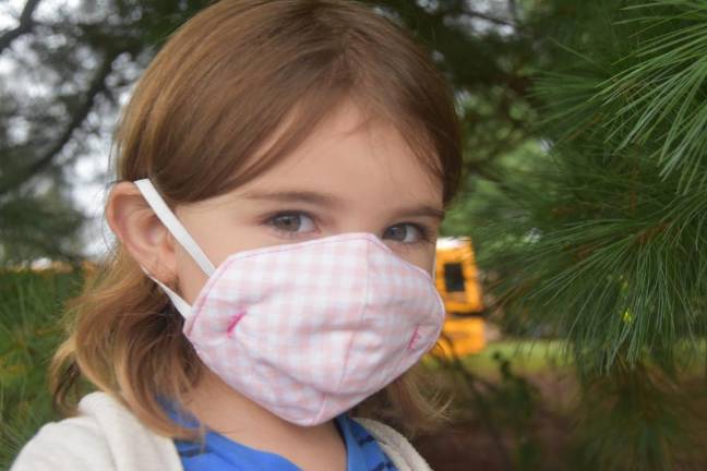 Ninth-grader Brianna Chinas found a niche sewing youth-sized masks. She hopes that masks that colorful masks that fit well will make kids “feel more excited -- at least a little bit more,” about wearing one all day.