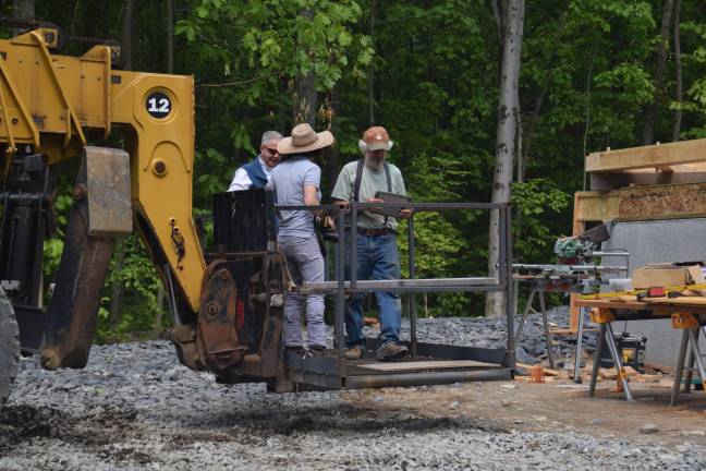 Timberframer Mike Moore offered this reporter a ride in the bucket for a bird's eye view.