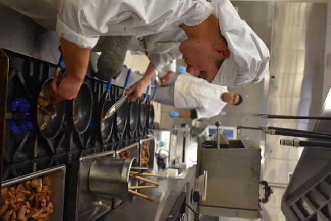 Brandon Bryett, 18, cooking up some of the 27 pounds of sausage from Banbury Cross Farm.