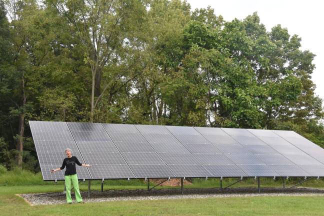 Endico in front of the solar array that should cover the couple's energy costs for the rest of their lives.