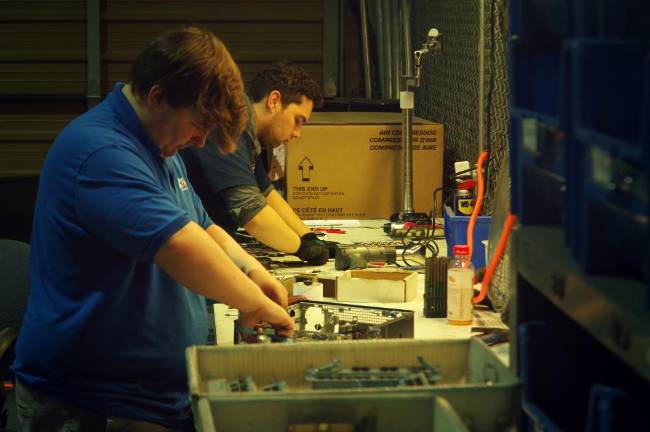 Workers parting out components at the warehouse in Franklin, NJ.