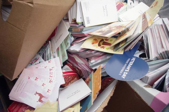 One dumpster holds thousands of holiday cards, including, ironically, gratitude cards from Thanksgiving.