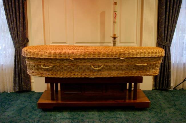 A wicker casket on display in a viewing room at M. John Scanlan Funeral Home in Pompton Plains, NJ, a fourth-generation family funeral parlor.