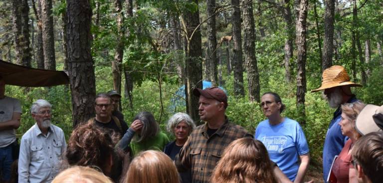 Camp “elders” assemble alongside Bill Marple, the tracking instructor. “Everyone over the age of 55, stand with me,” said Marple. “These would be our elders. They got some things to share. They want to help. The elders are the people who hold the culture. These are the people who really know,” he said. “I don’t like the relationship we have in present society” to our elders, whom we often set aside, he said. At that afternoon’s feast, the elders ate first, and they sat in front at the sweat lodge that night.