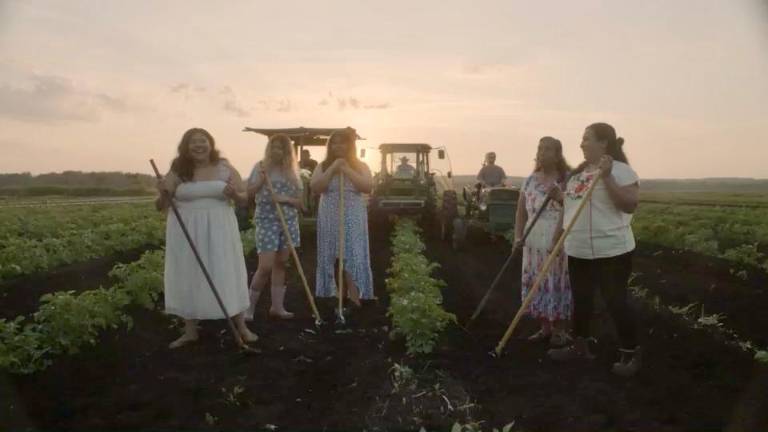 Ana Angel, right, with her daughters on their farm.