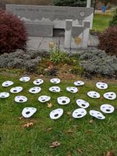 Cox made 22 paper masks and laid them out in Warwick’s Memorial Park.