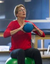 Geralyn Ritter, 47, Whitehouse, NJ, grimaces as she holds an 8 lb weighted ball and twists back and forth during physical therapy May 1, 2016, almost one year after surviving the May 12, 2015 Amtrak train #188 crash in Philadelphia. Ritter, a corporate lawyer and mother of three boys, was the most severely injured survivor of the crash. She has not been able to return to work yet. CLEM MURRAY