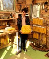 Chandler Alysia Mazzella holds 20 pounds of local beeswax in her studio in Newburgh, NY.