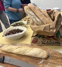 The writer’s homemade bread alongisde some of the other dishes at the last cookbook club meeting.