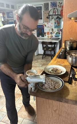 Joe Gara turning an old laying hen into ground chicken
