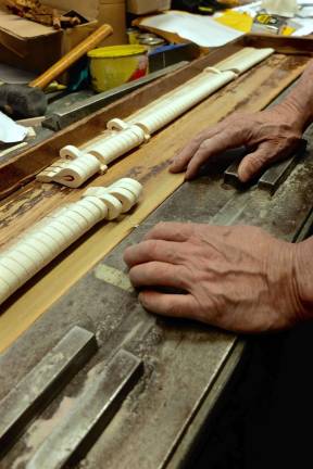 Ray checks each piano hammer before boxing and mailing to his customers.