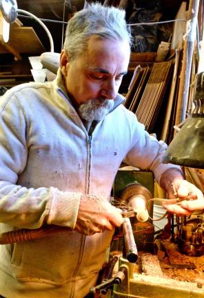 Tom Andreas turning a drawer pull on his lathe. Often he&#x2019;ll choose a piece of spalted wood, whose fungi colonies make for interesting colors and patterns.