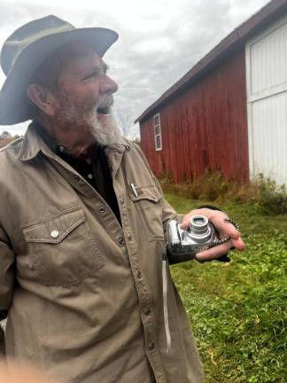 Stewart multitasking: giving a tour of his farm, documenting the visit and taking time to introduce one of the farm’s smaller residents
