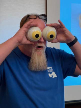 Educator Carl Heitmuller at Hudson Highlands Nature Museum demonstrating the proportional size of an owl’s eyes.