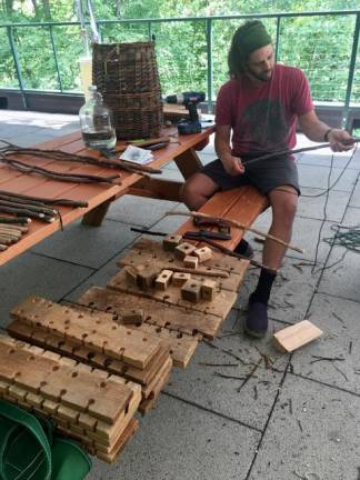 Zach Fisher repairing equipment for the Native American Lifeways program at Mohonk Mountain.