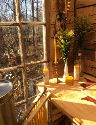 Freshly-made hanging tapers, prayer candles, a mirth pillar, vases of goldenrod, and the view from Mazzella's studio.