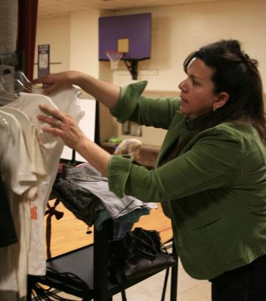 Rosa Atamyildiz, of Warwick, volunteers at the Hope Chest/Clothing Closet, sorting donations in the former PIES gymnasium. Photo by Raheli Harper.