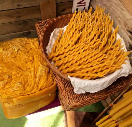 Large blocks of beeswax and a basket of Mazzella's newest candle style, the Twin Flame Taper, which she says is Ideal for meditating on two or more possibilities, or when celebrating the ending and the beginning.