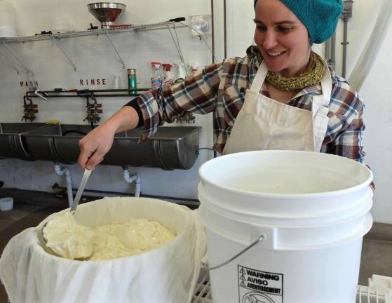 ladling curds into a butter muslin lined mold