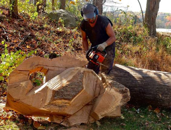 Fidias Vasquez carving a dragon for Luft Gardens Art Park.