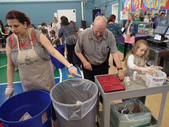 BT: An aide, a janitor and a first-grader work side by side, helping students sort compost from recyclables from trash at the end of a lunch period. Photo by Becca Tucker
